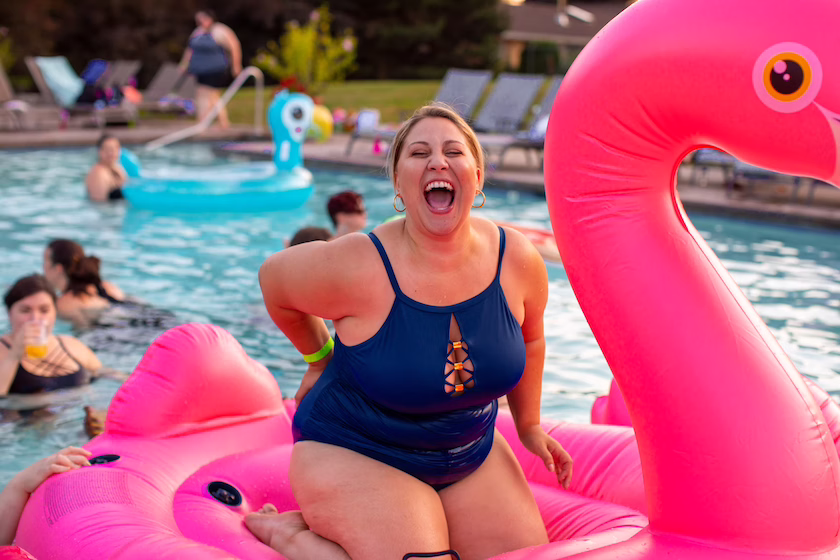 Eine Frau im Schwimmbad auf einem Flamingo